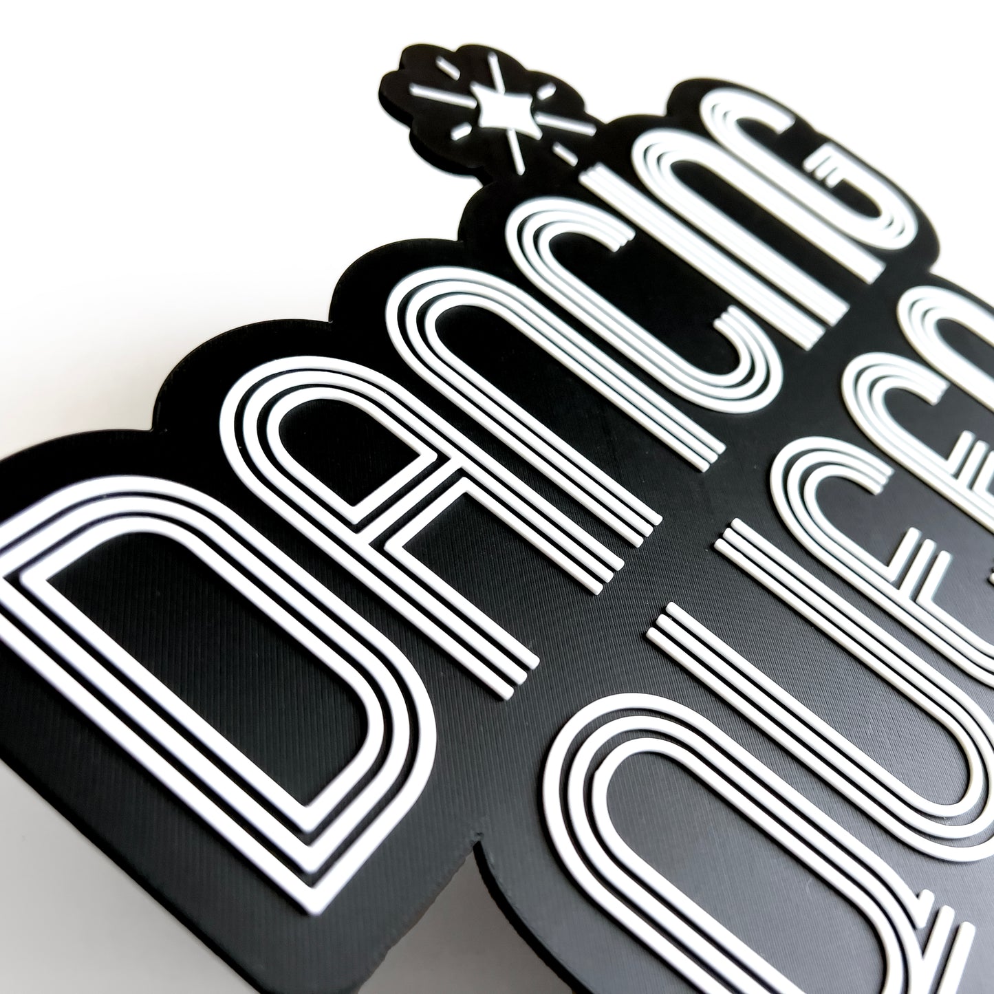 Close up of a black and white sign photo booth prop that says "Dancing Queen"