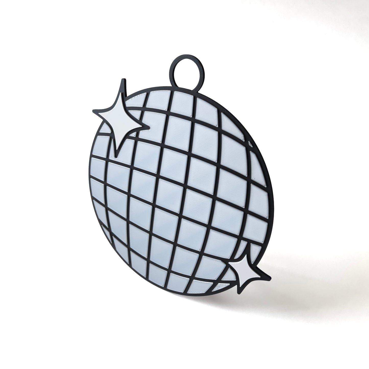3D printed disco ball prop sign with reflective silver tiles and white sparkle accents.