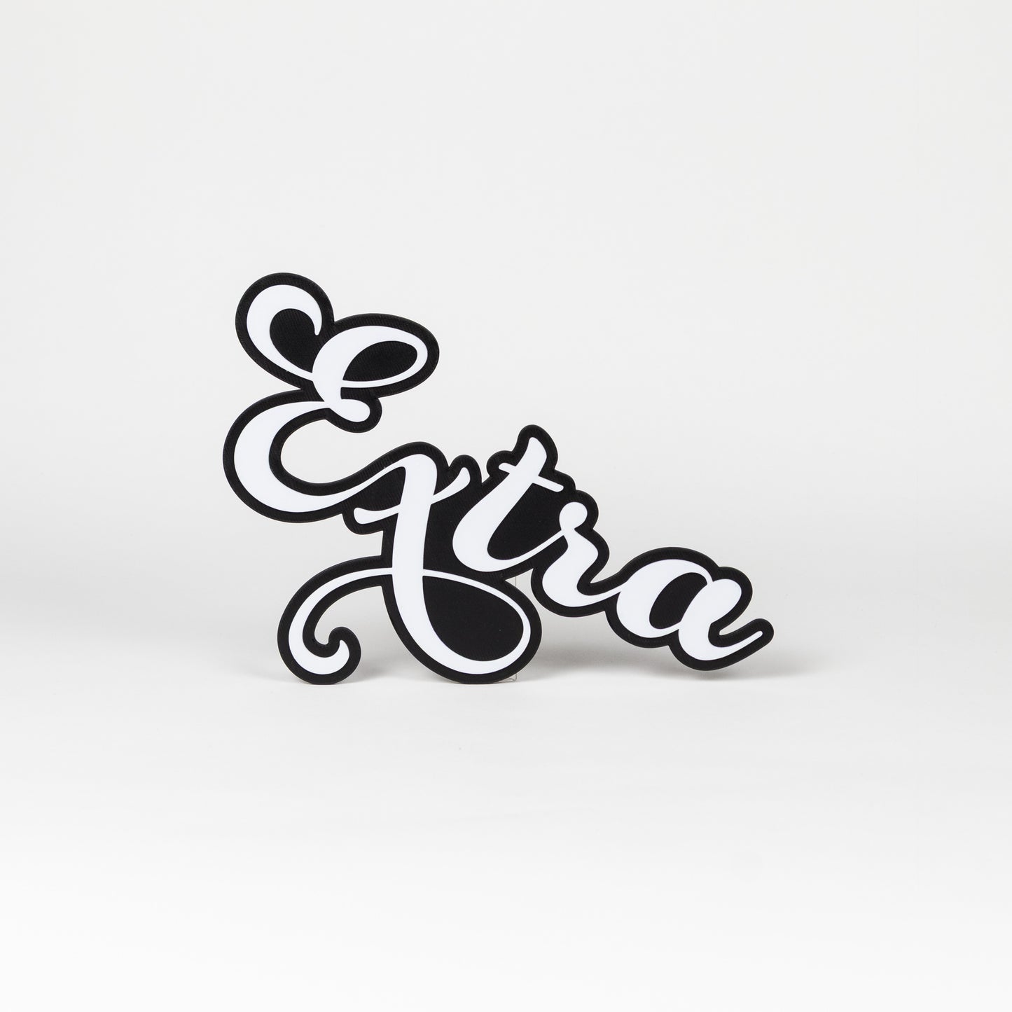Black and white photo booth prop that says 'Extra' on a white background.