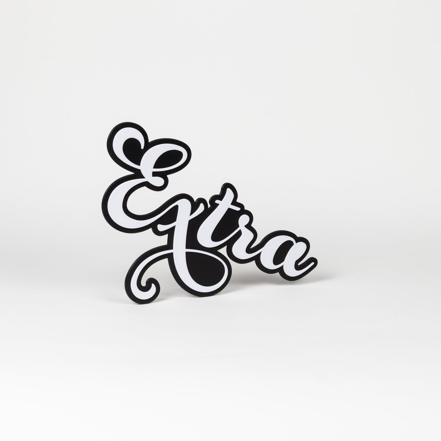 Black and white prop sign with 'Extra' text on a white background