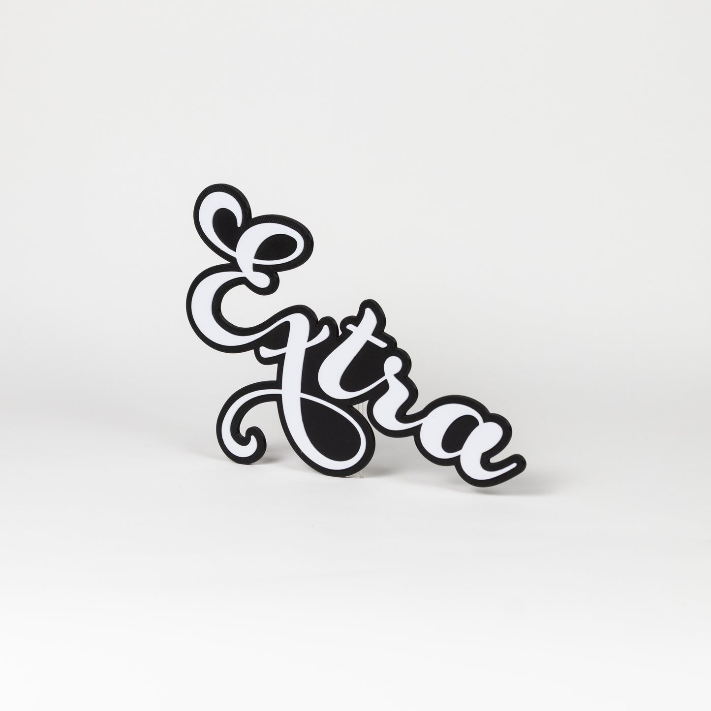 Photo booth prop sign 'Extra', white letters with a black outline on a white background