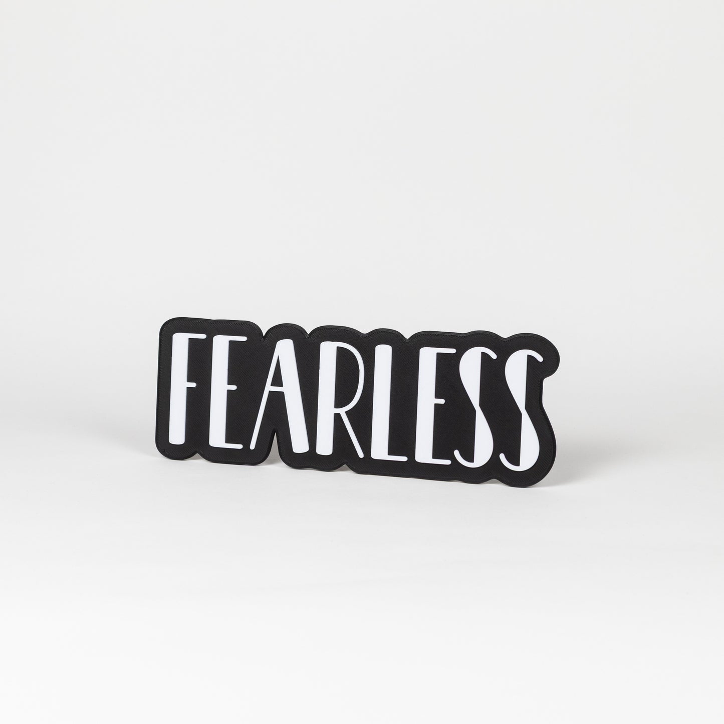 Black and white 'FEARLESS' sign on a white background