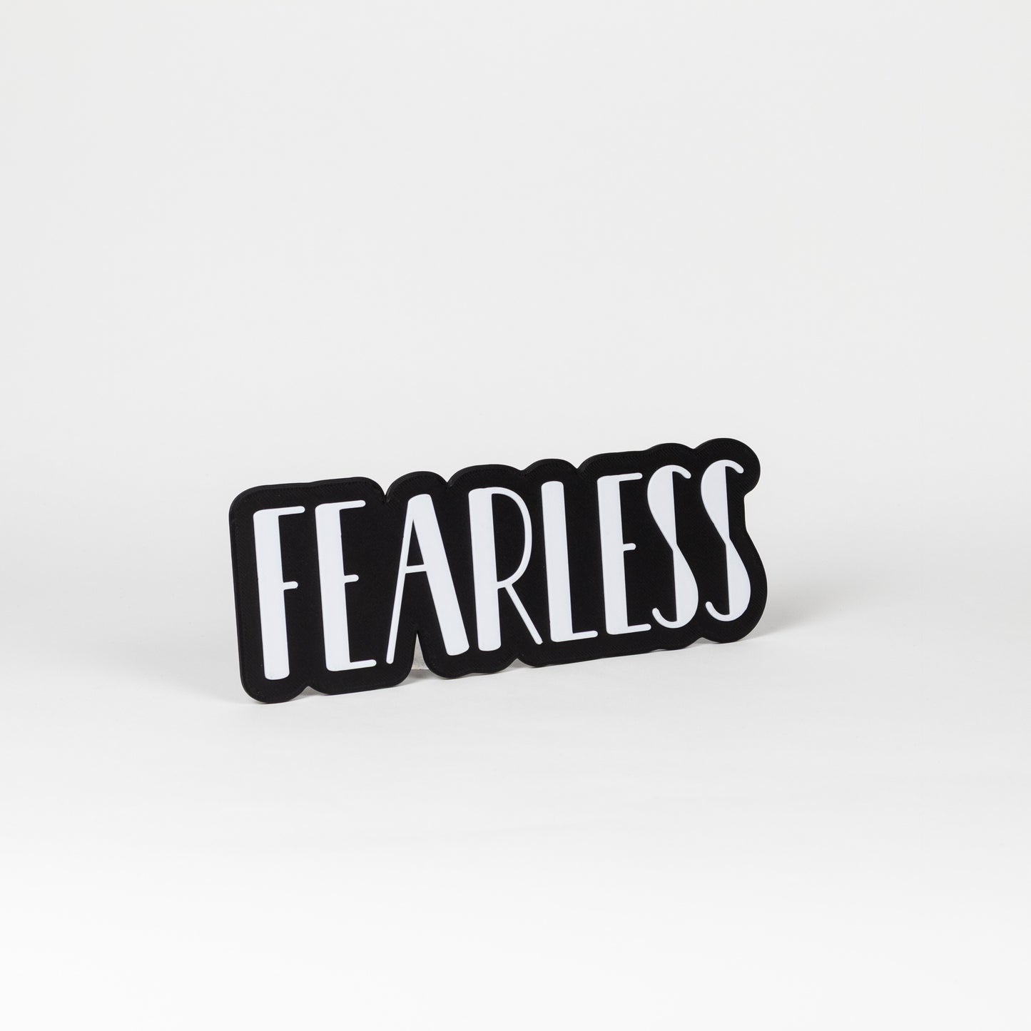 Black and white 'FEARLESS' prop sign on a white background