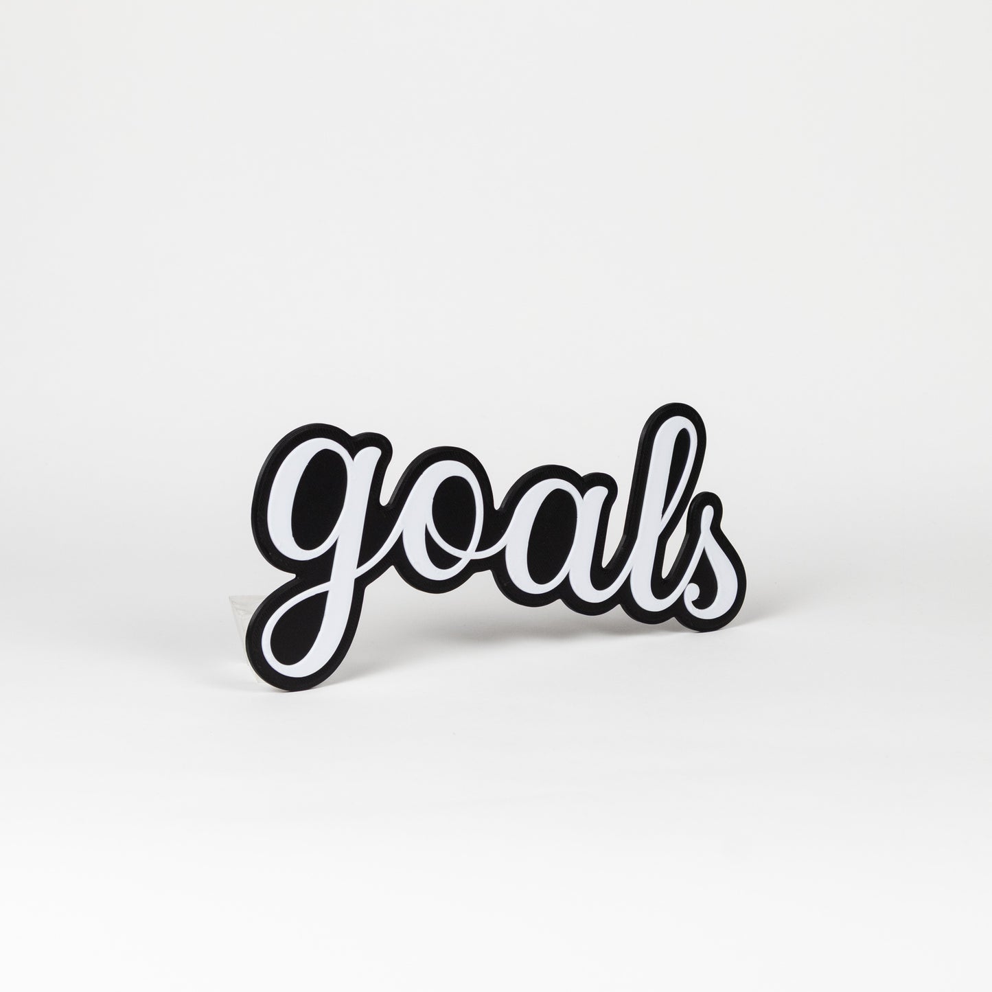 Black and white photo booth prop 'goals' on a white background
