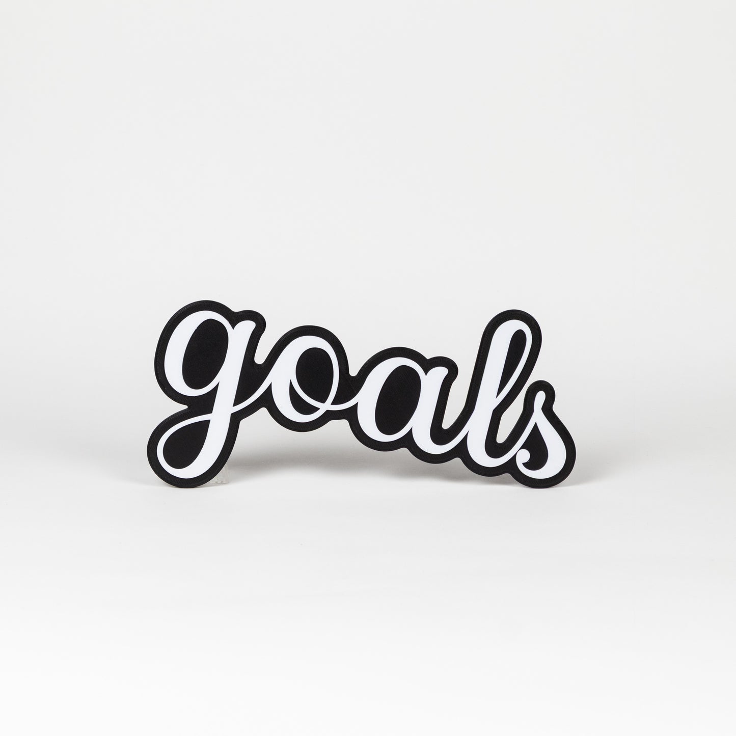Black and white 'goals' prop on a light gray background