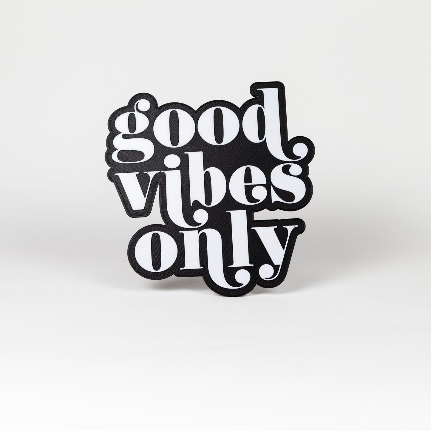 Photo booth sign with 'good vibes only' white text on a black base. Shot on a white background