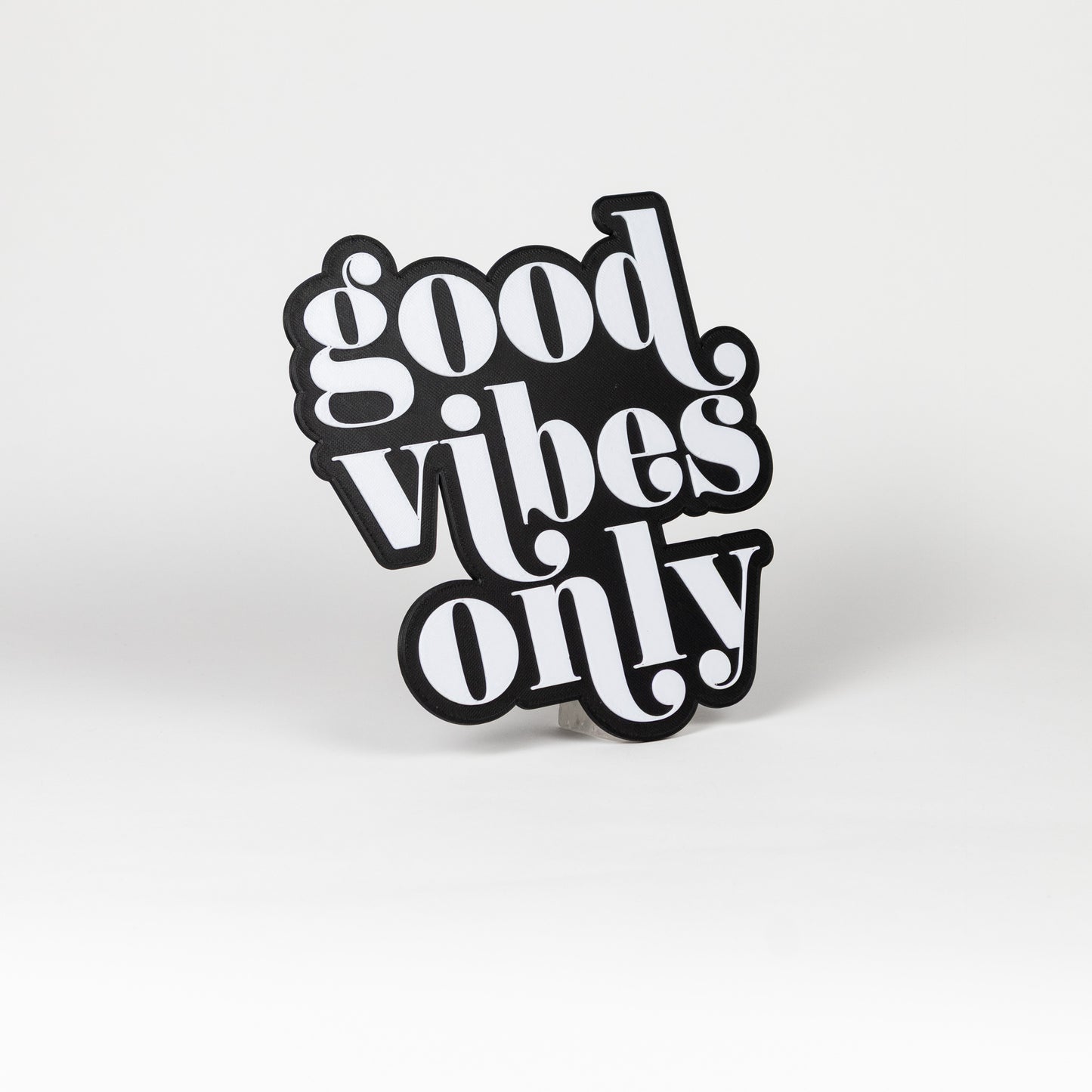 Black and white 'good vibes only' sign on a white background