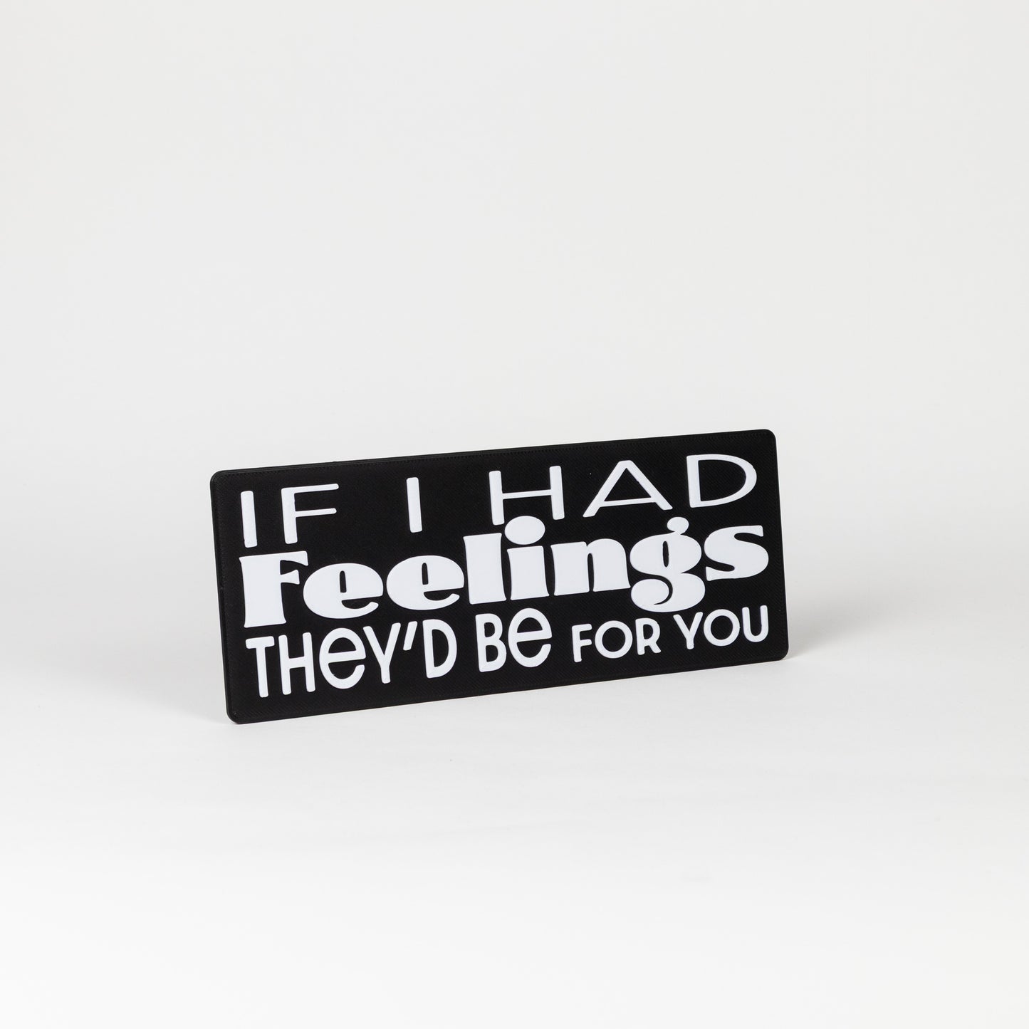 Black sign with white text 'If I had feelings they'd be for you' on a white background