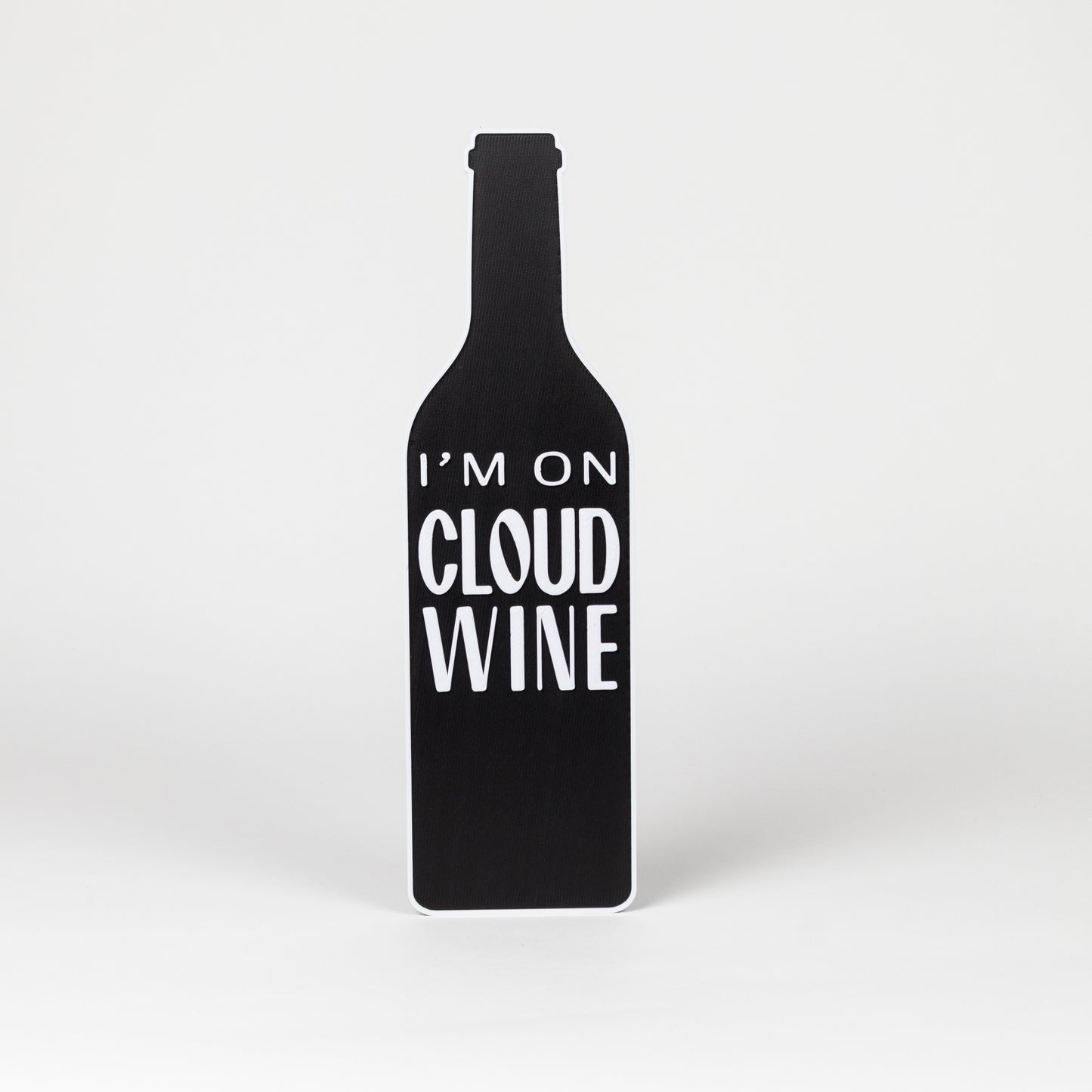 Black wine bottle-shaped sign with 'I'm on Cloud Wine' text on a white background