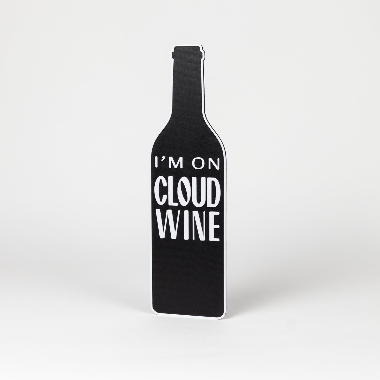 Photo booth prop. Black wine bottle-shaped sign with 'I'm on Cloud Wine' text on a white background