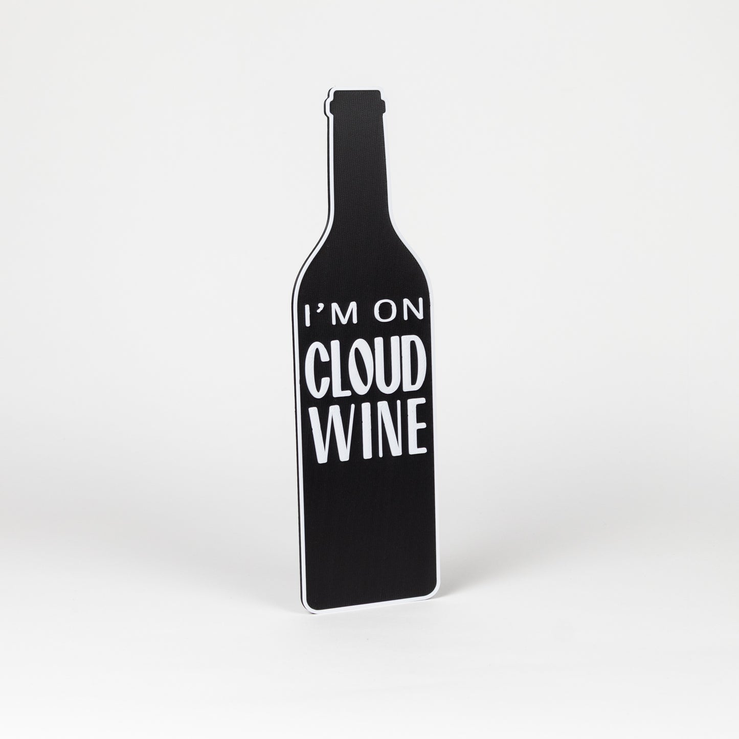 Photo booth prop. Black wine bottle-shaped object with 'I'm on Cloud Wine' text on a white background