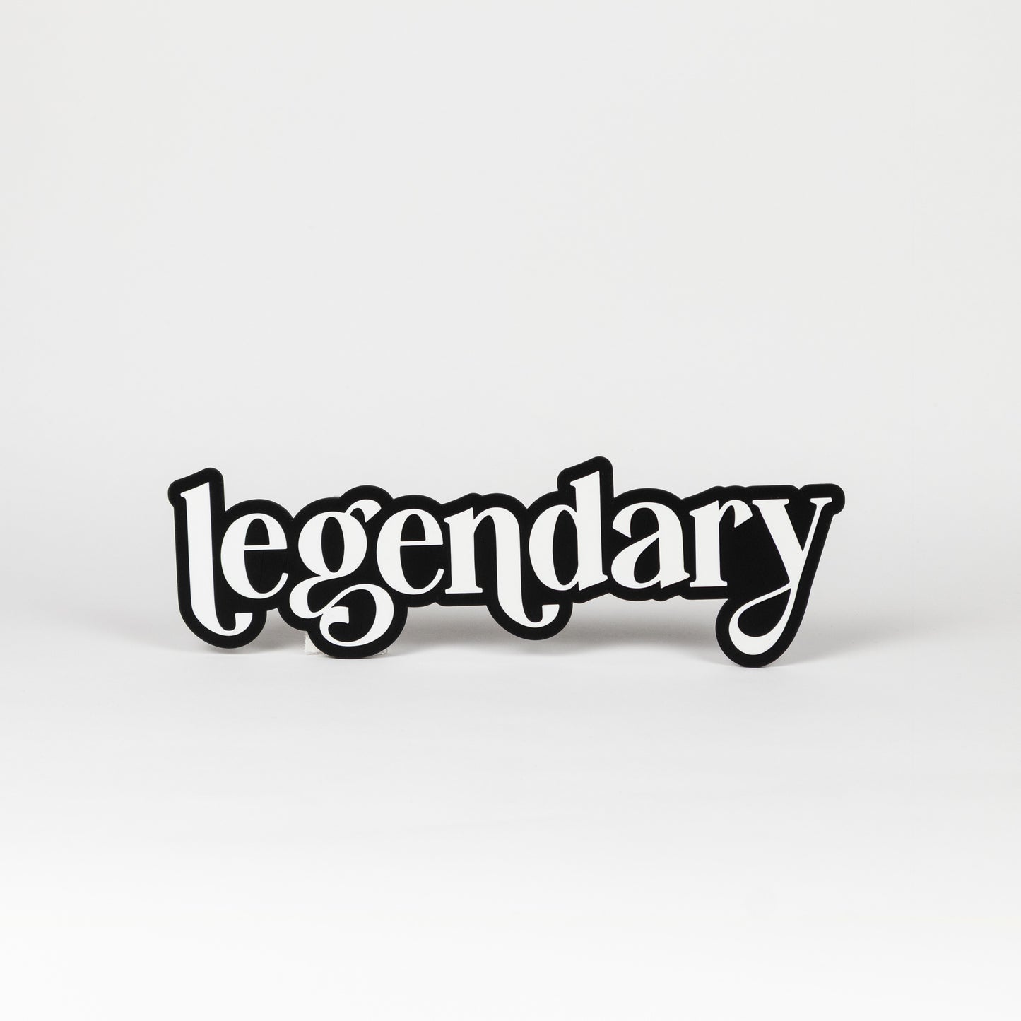 Photo booth prop sign. Black base with white 'legendary' text on a white background