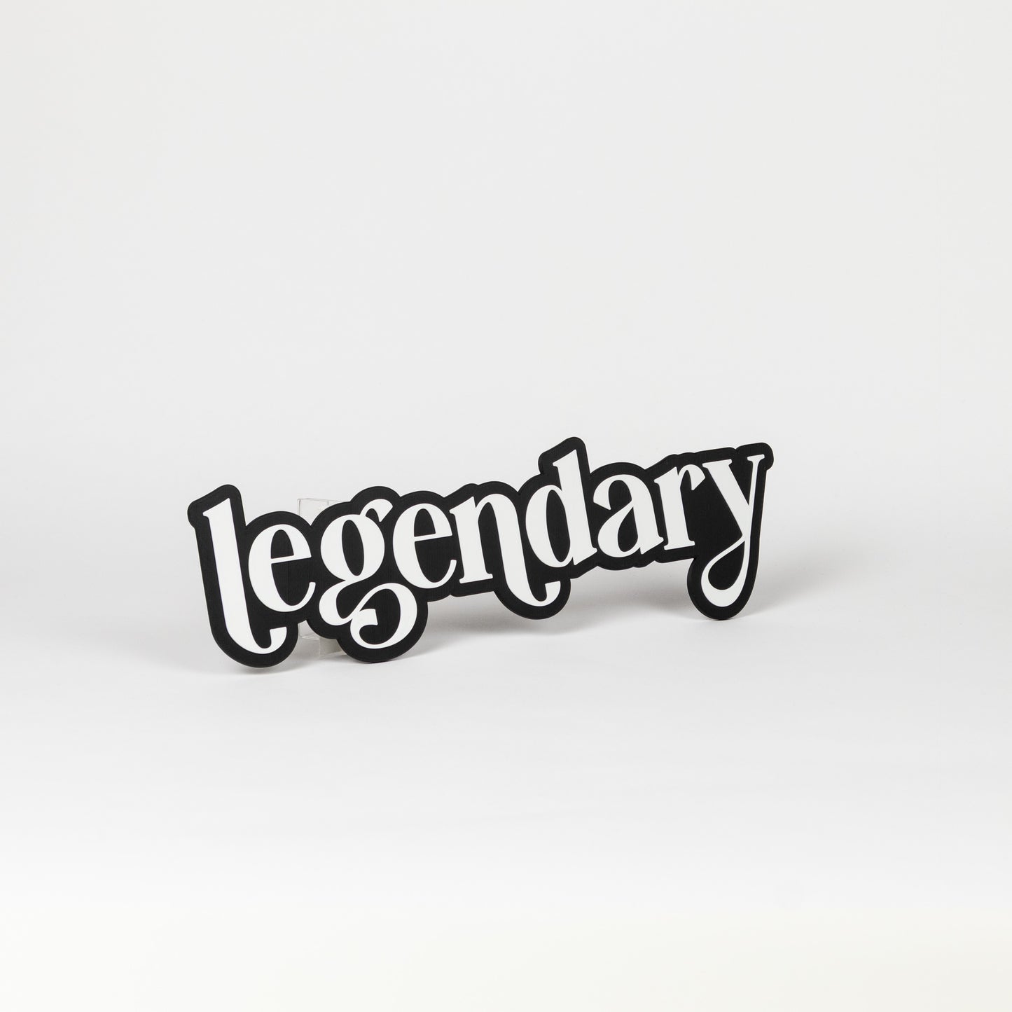Photo booth prop sign. Black base with white 'legendary' text on a white background