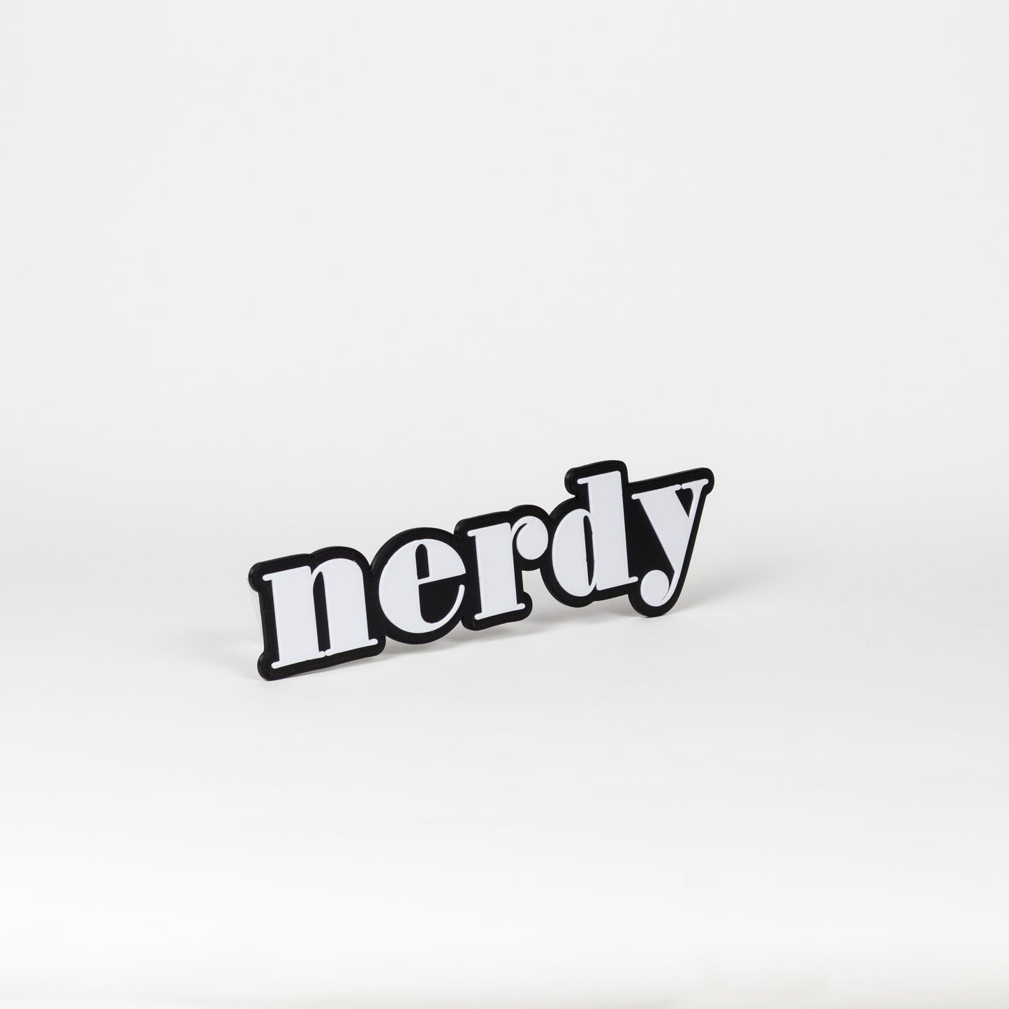 Black and white sign prop of the word 'nerdy'