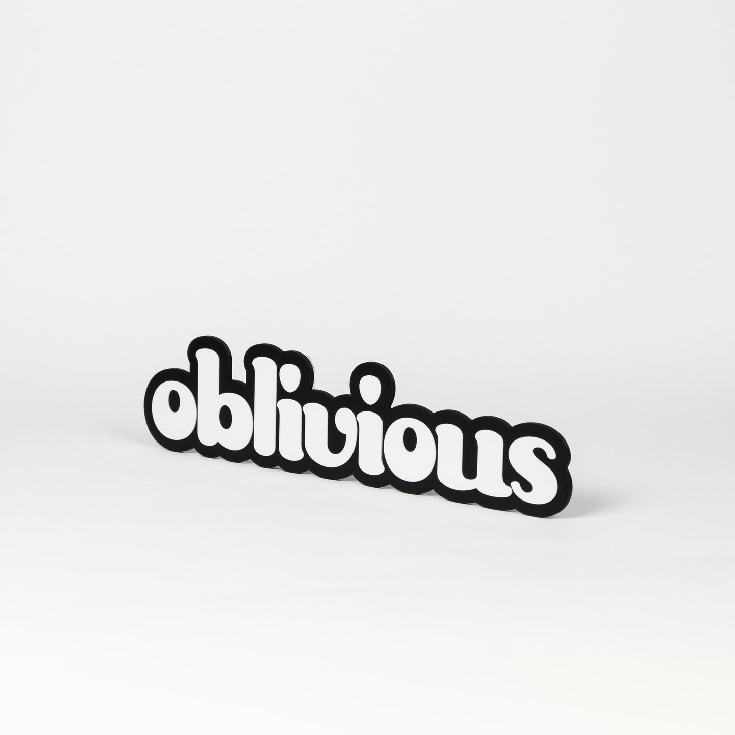 Black and white photo booth prop of the word 'oblivious'.