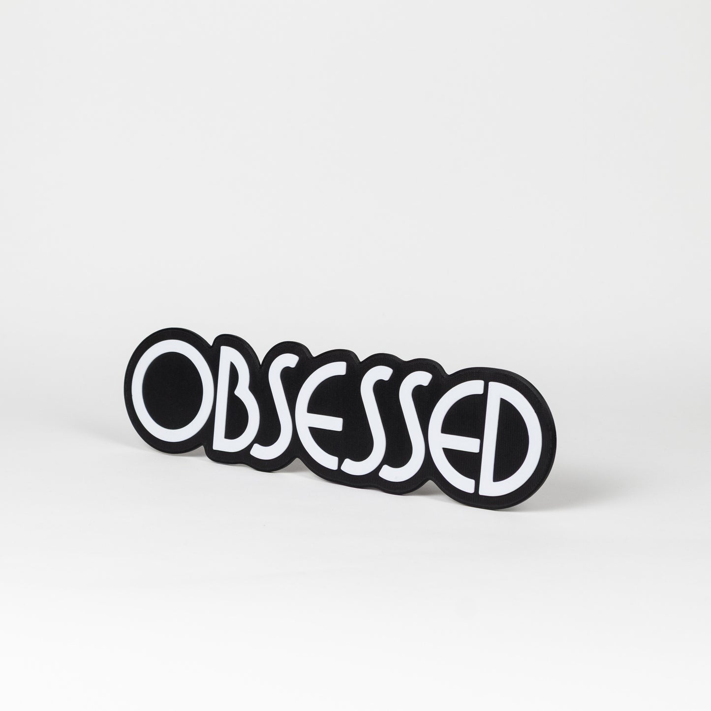 Black and white "Obsessed" sign. Photo booth prop.