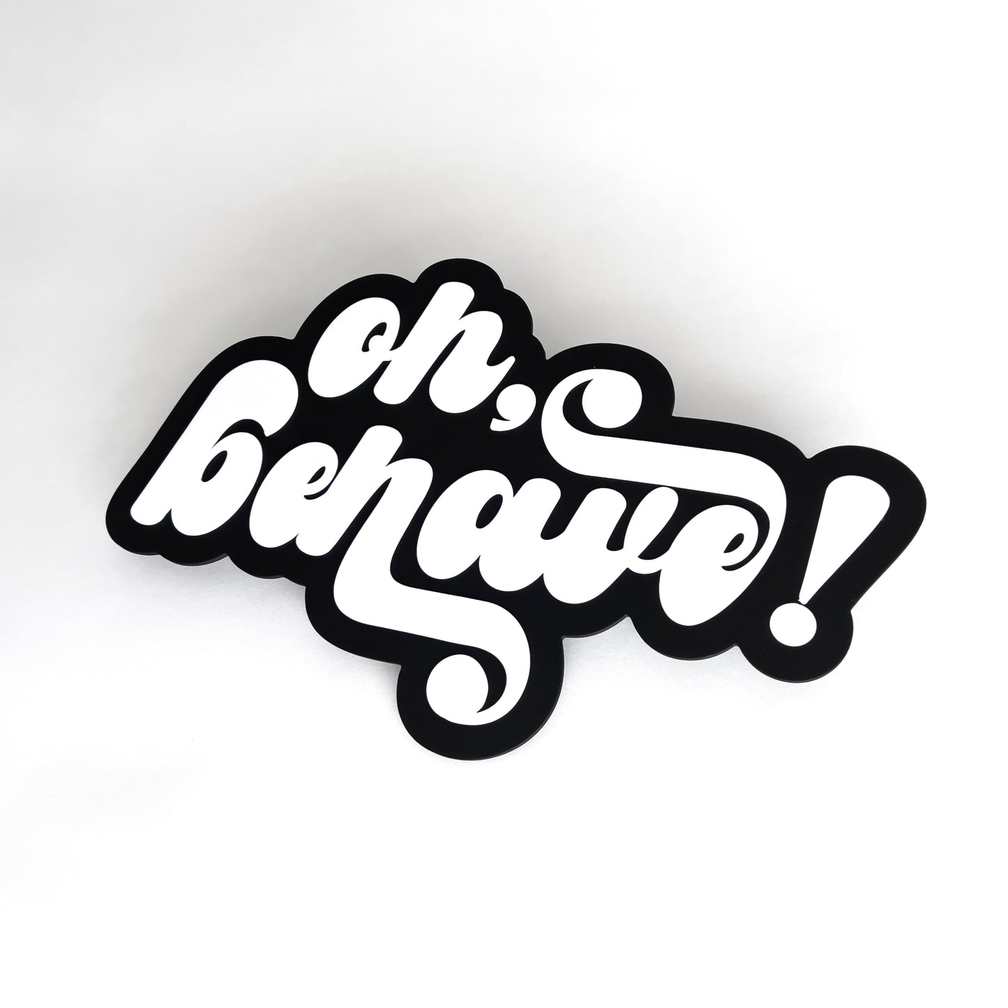 Black and white photo booth prop sign that says "oh, behave!". On a white background