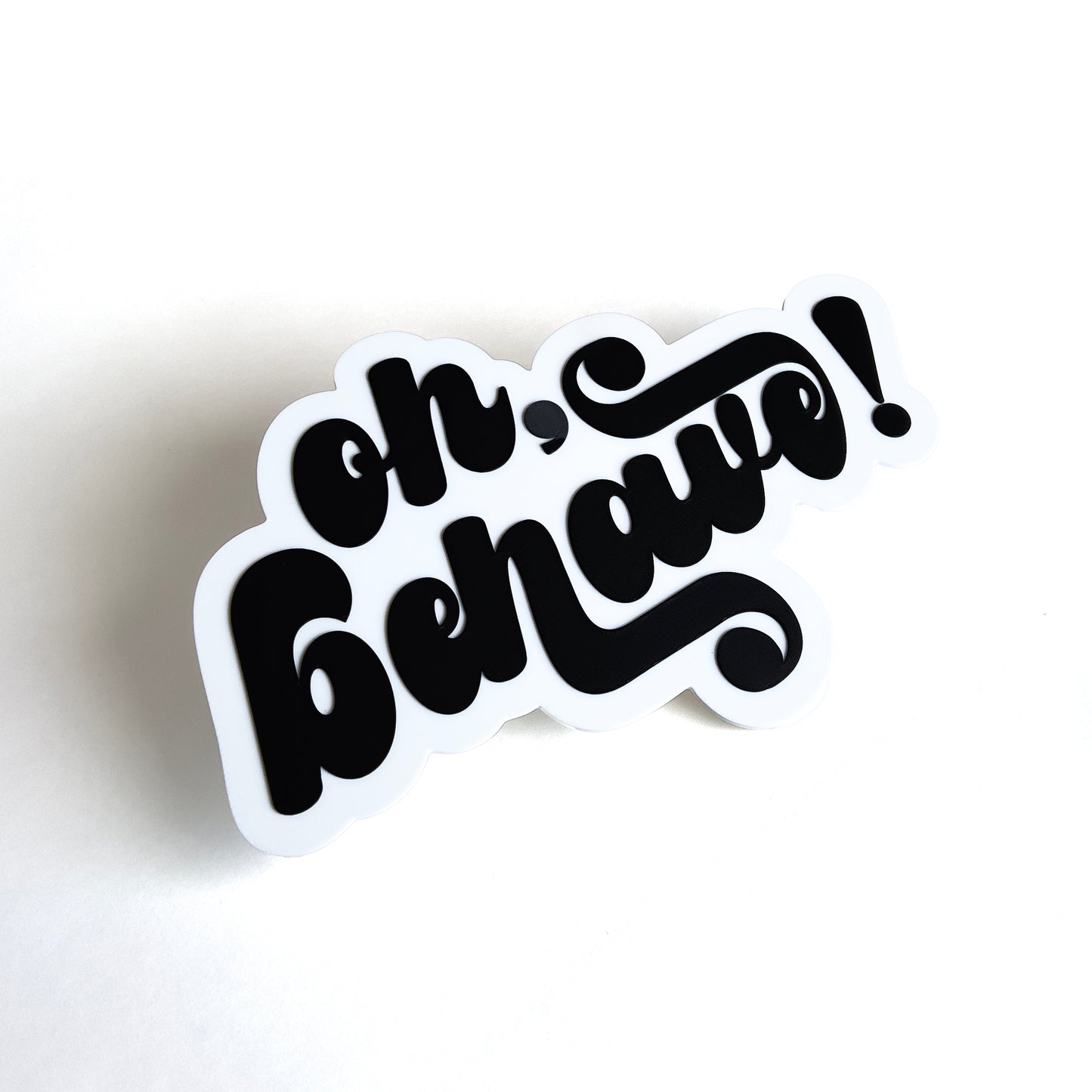 White and black photo booth prop sign that says "oh, behave!".