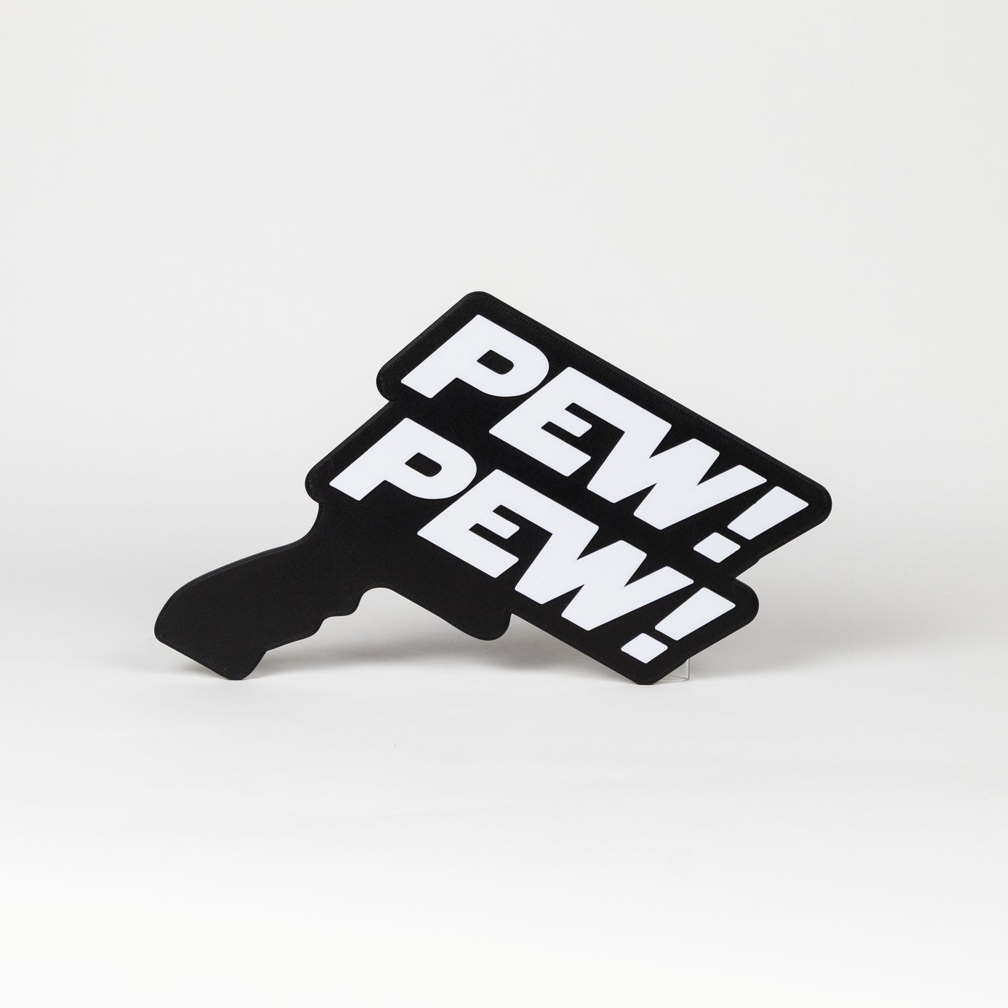 Black and white sign that says "Pew Pew!". Sign is in the shape of a Star Wars blaster. Photo booth prop.