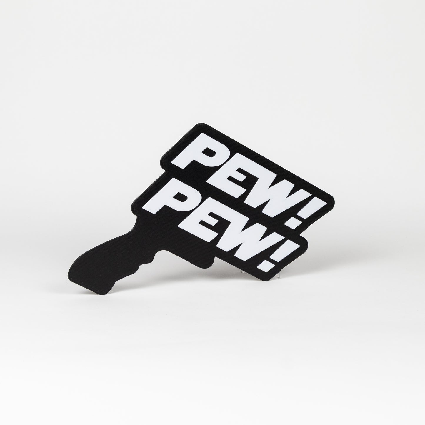 Black and white sign that says "Pew Pew!". Sign is in the shape of a Star Wars blaster. Photo booth prop.