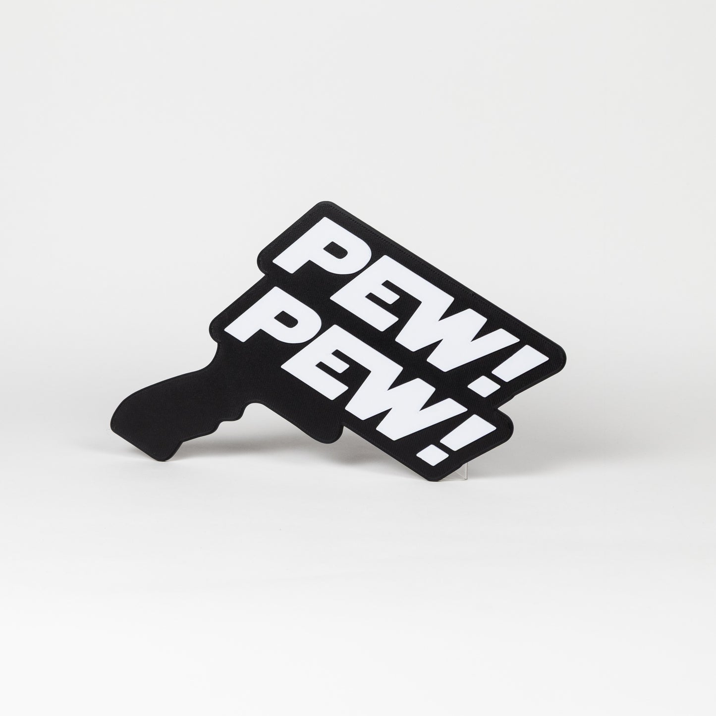 Black and white sign that says "Pew Pew!". Sign is in the shape of a Star Wars blaster. Photo booth prop.