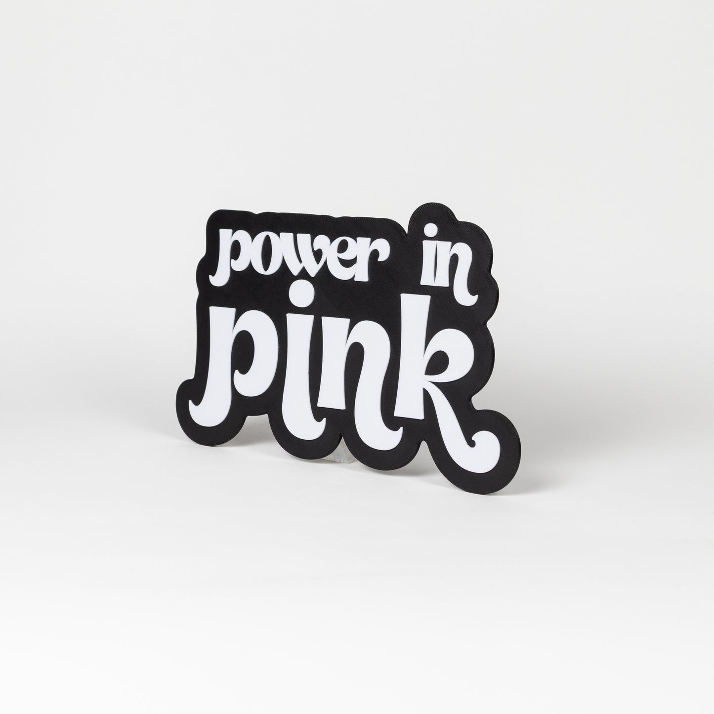 Black and white "Power In Pink" sign. Photo booth prop.