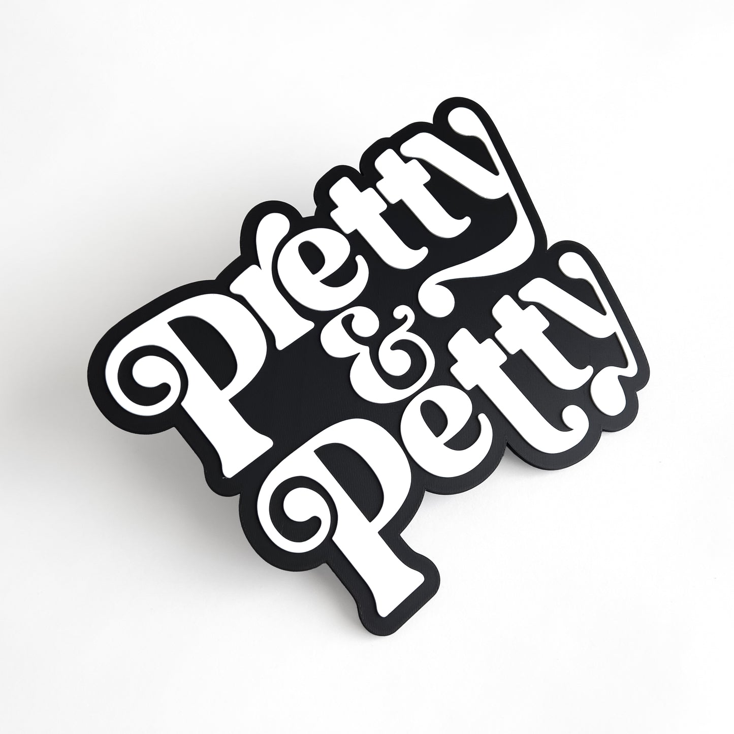 Black and white sign that says "Pretty and Petty" for photo booth events.