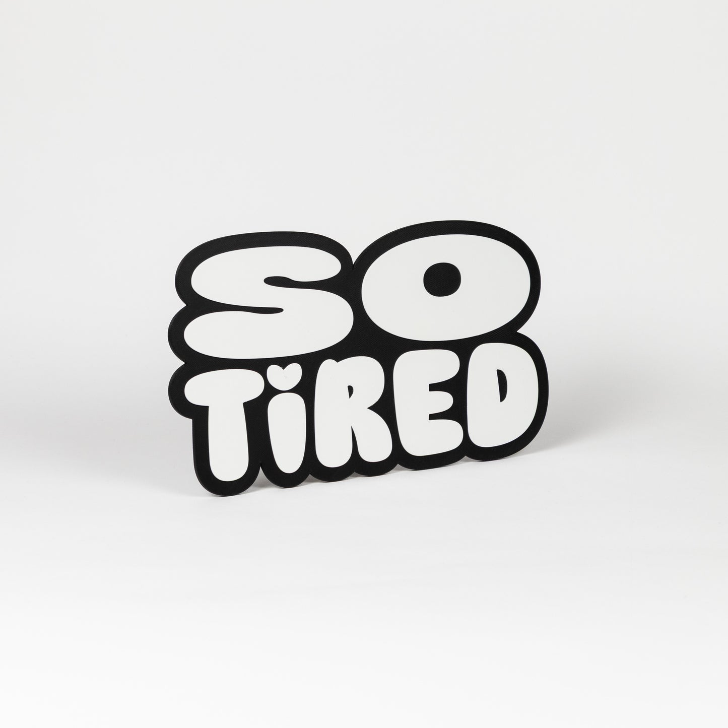 Black and white "So Tired" sign. Photo booth prop.