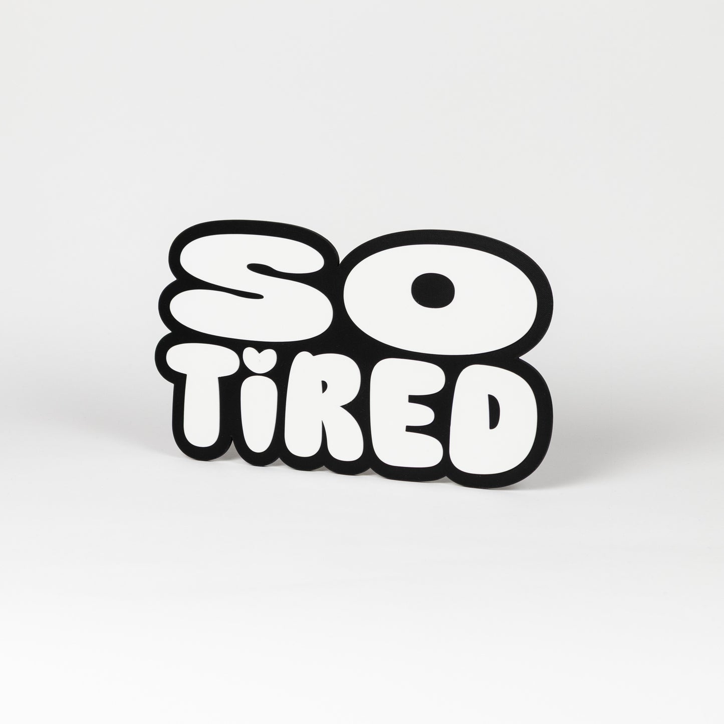 Black and white "So Tired" sign. Photo booth prop.