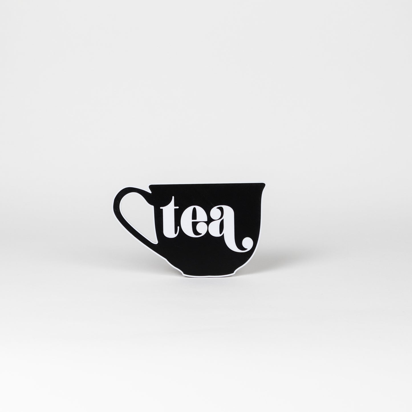 Black and white sign in the shape of a tea cup that says, "tea". Photo booth prop.