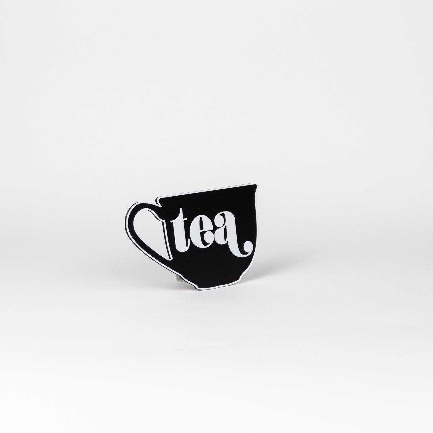 Black and white sign in the shape of a tea cup that says, "tea". Photo booth prop.