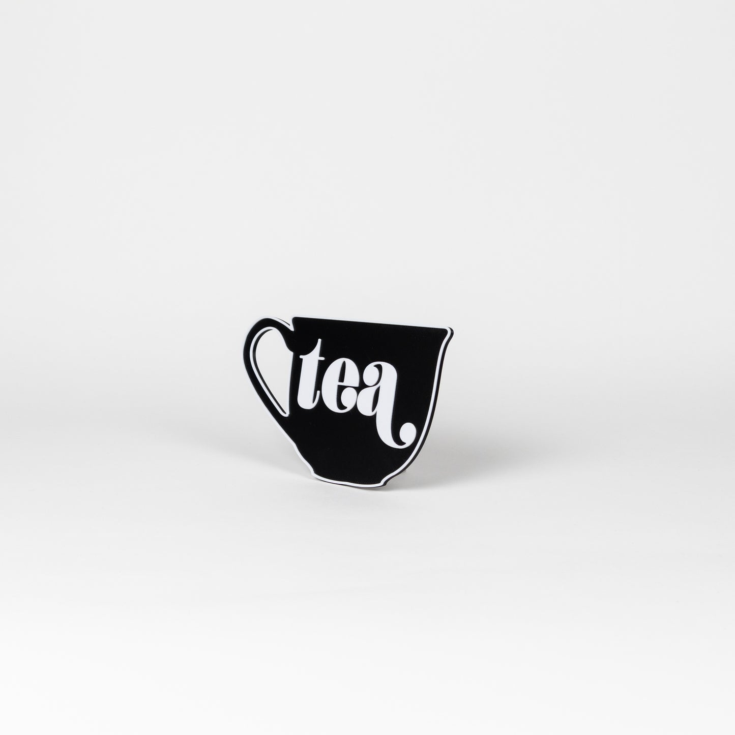 Black and white sign in the shape of a tea cup that says, "tea". Photo booth prop.