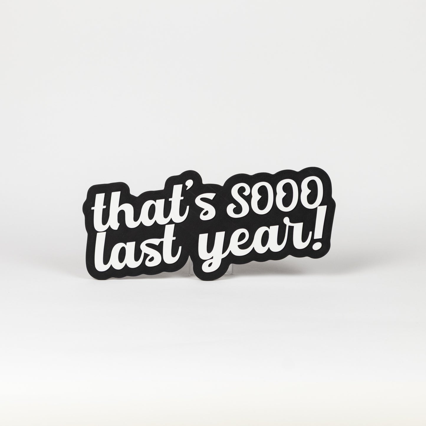 Black and white sign that says, "That's Sooo Last Year!". NYE photo party prop.