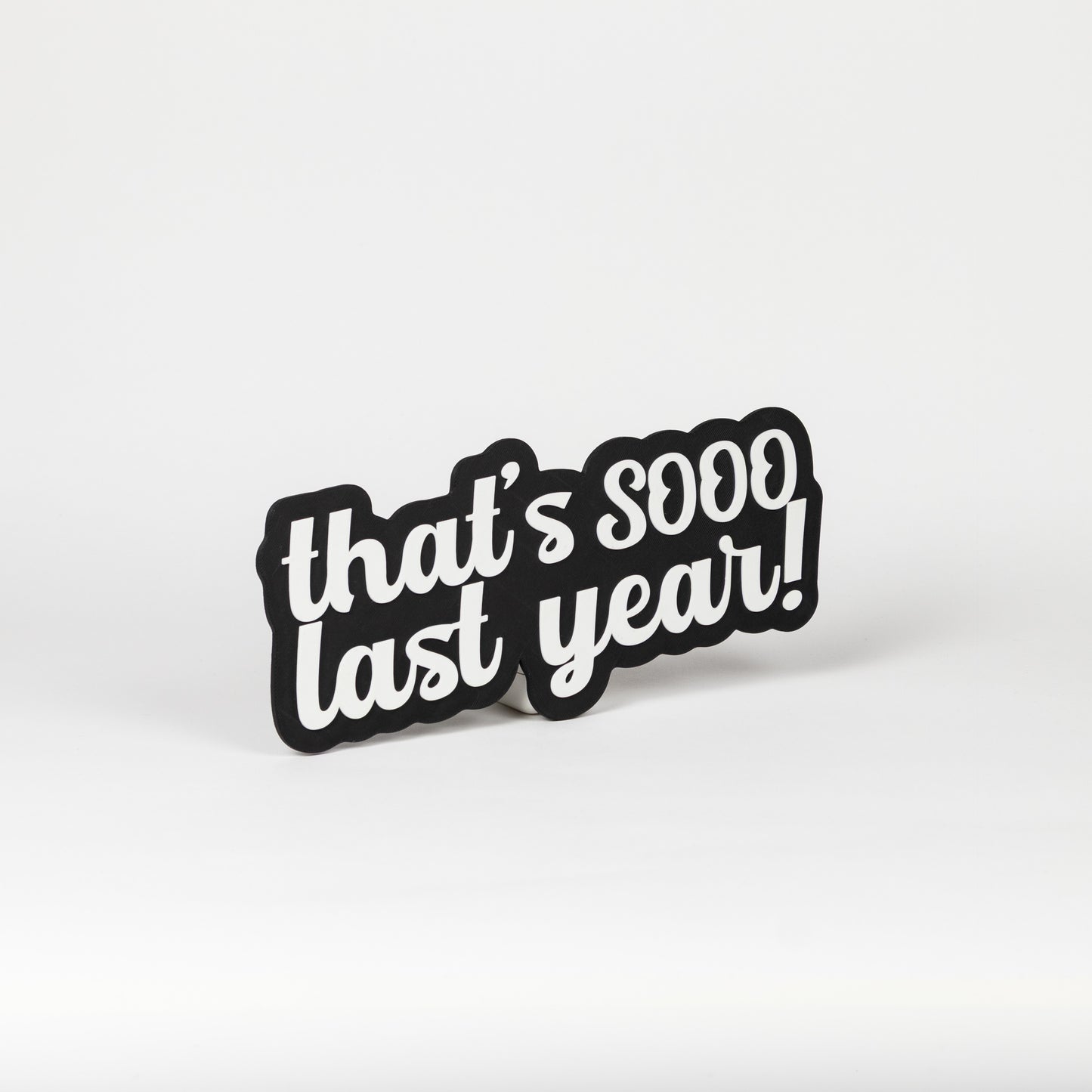 Black and white sign that says, "That's Sooo Last Year!". NYE photo party prop.