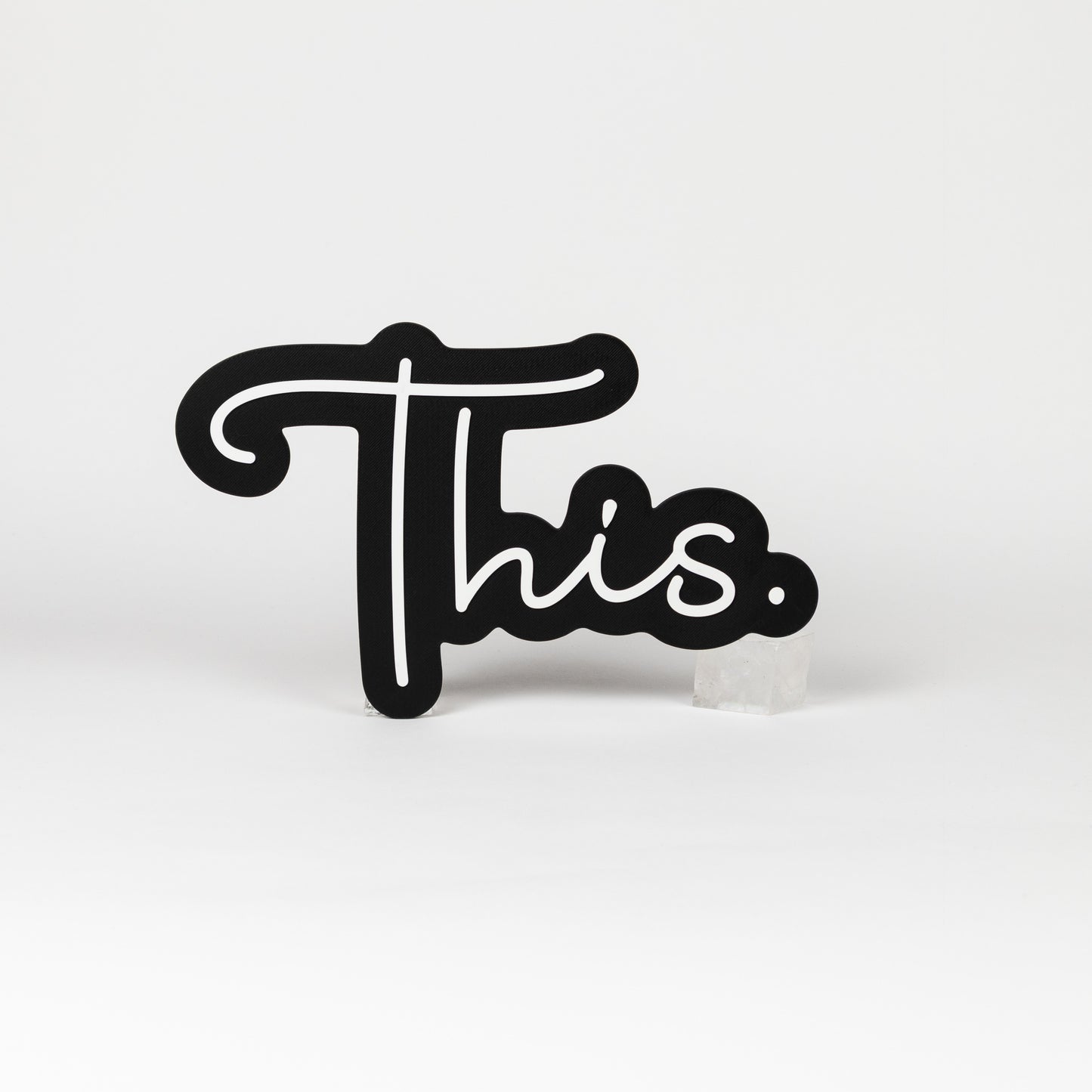 Black and white sign of the word "This." Photo booth prop of popular saying.