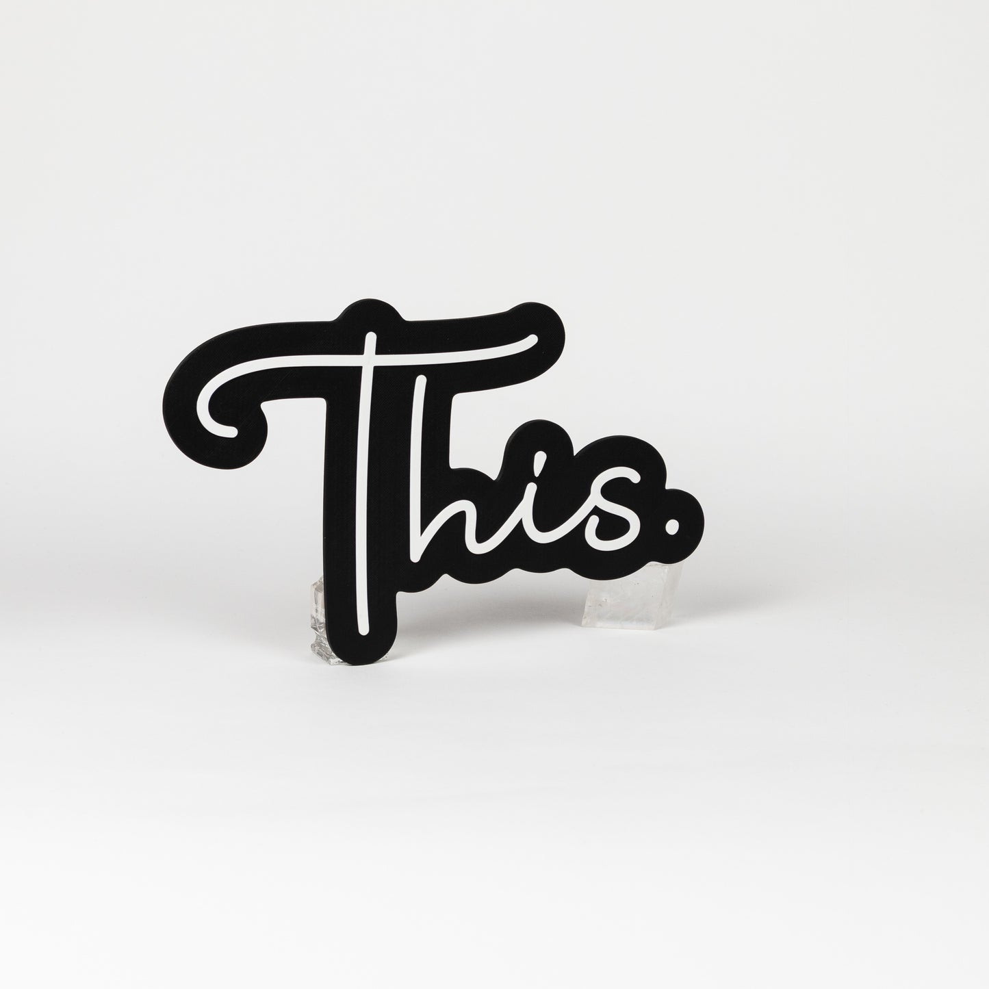 Black and white sign of the word "This." Photo booth prop of popular saying.