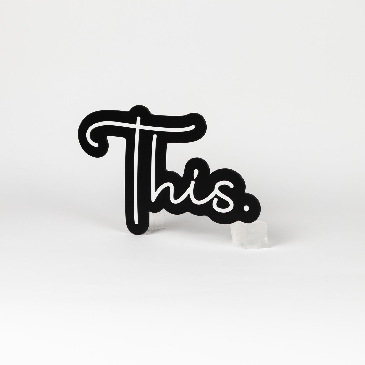 Black and white sign of the word "This." Photo booth prop of popular saying.