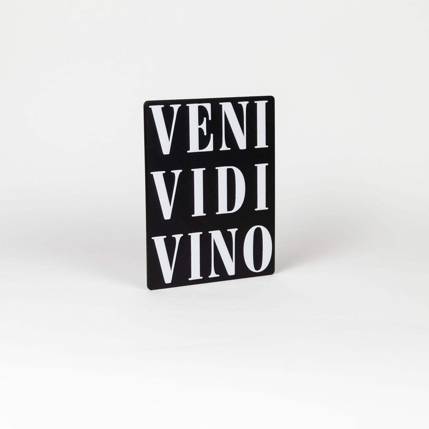 Wine themed black sign with white text 'VENI VIDI VINO'