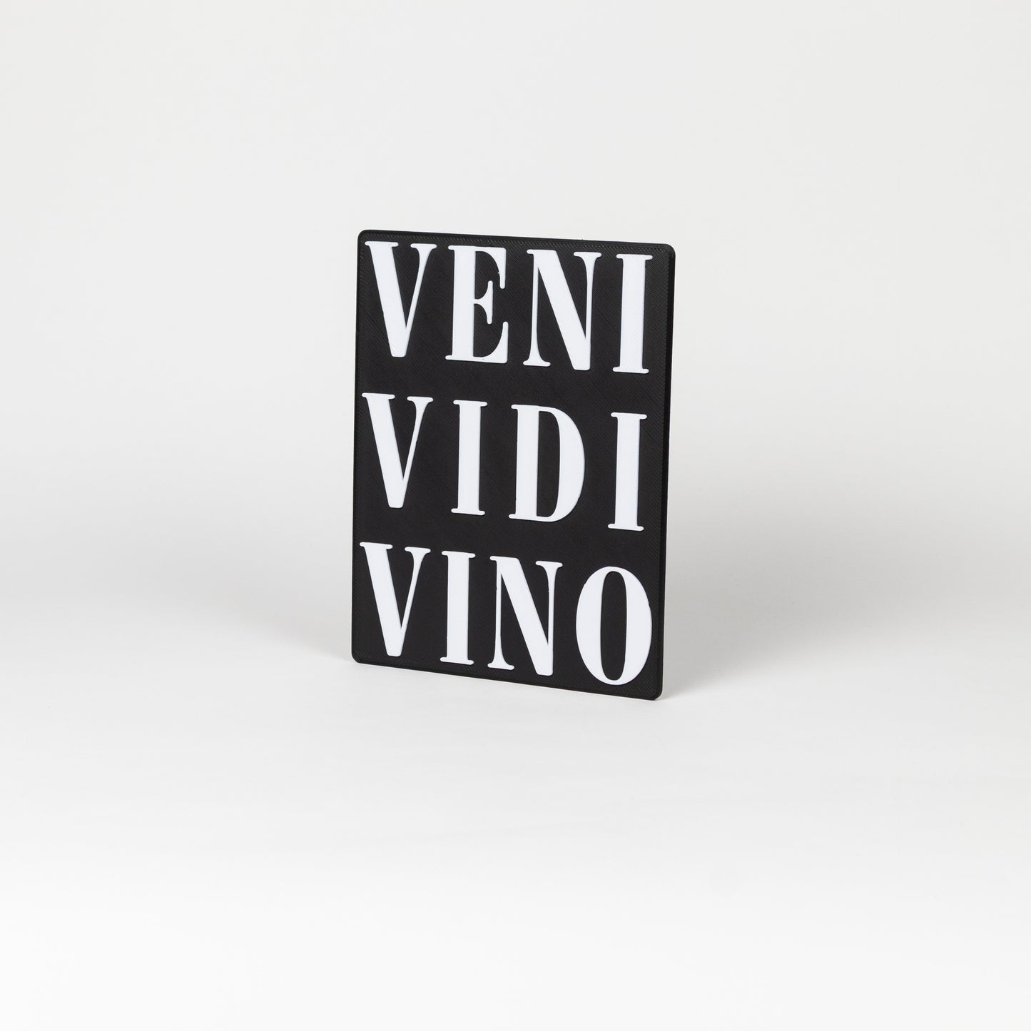 Wine themed black sign with white text 'VENI VIDI VINO'