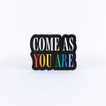 'COME AS YOU ARE' sign with 'YOU ARE' in colorful letters on a white background