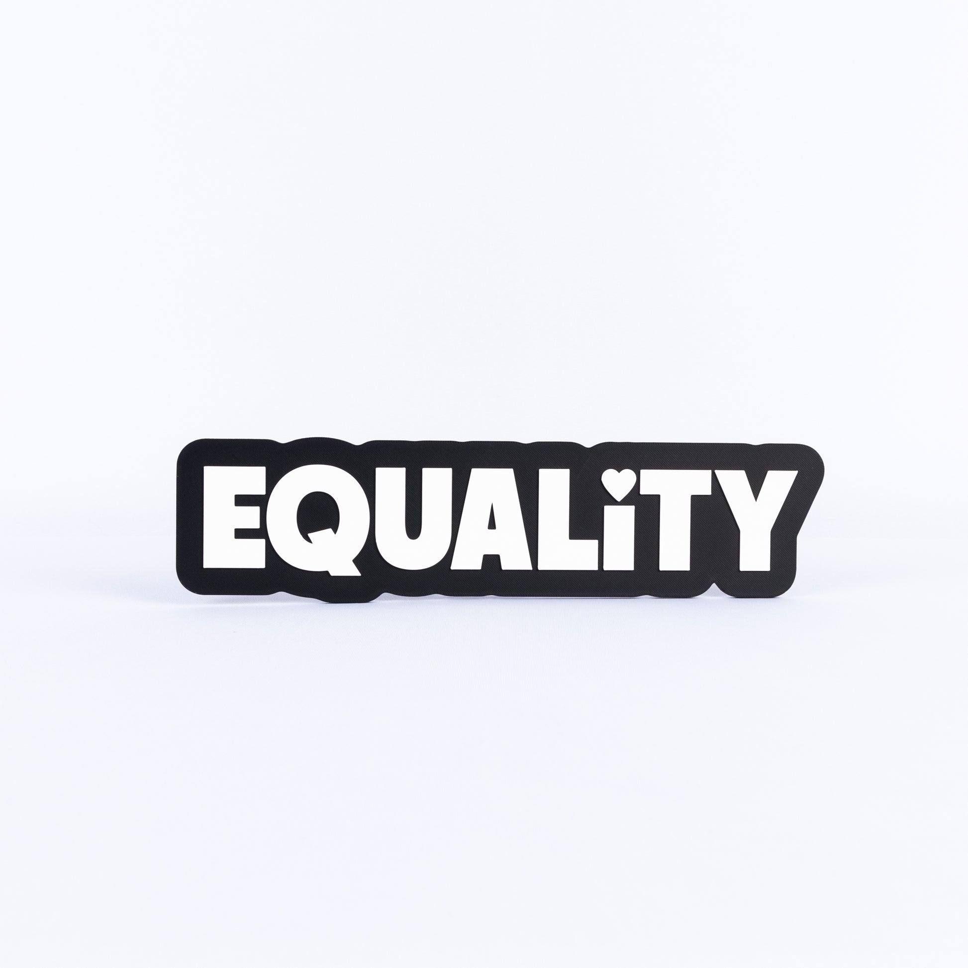 Black and white sign with the word 'EQUALITY' on a white background