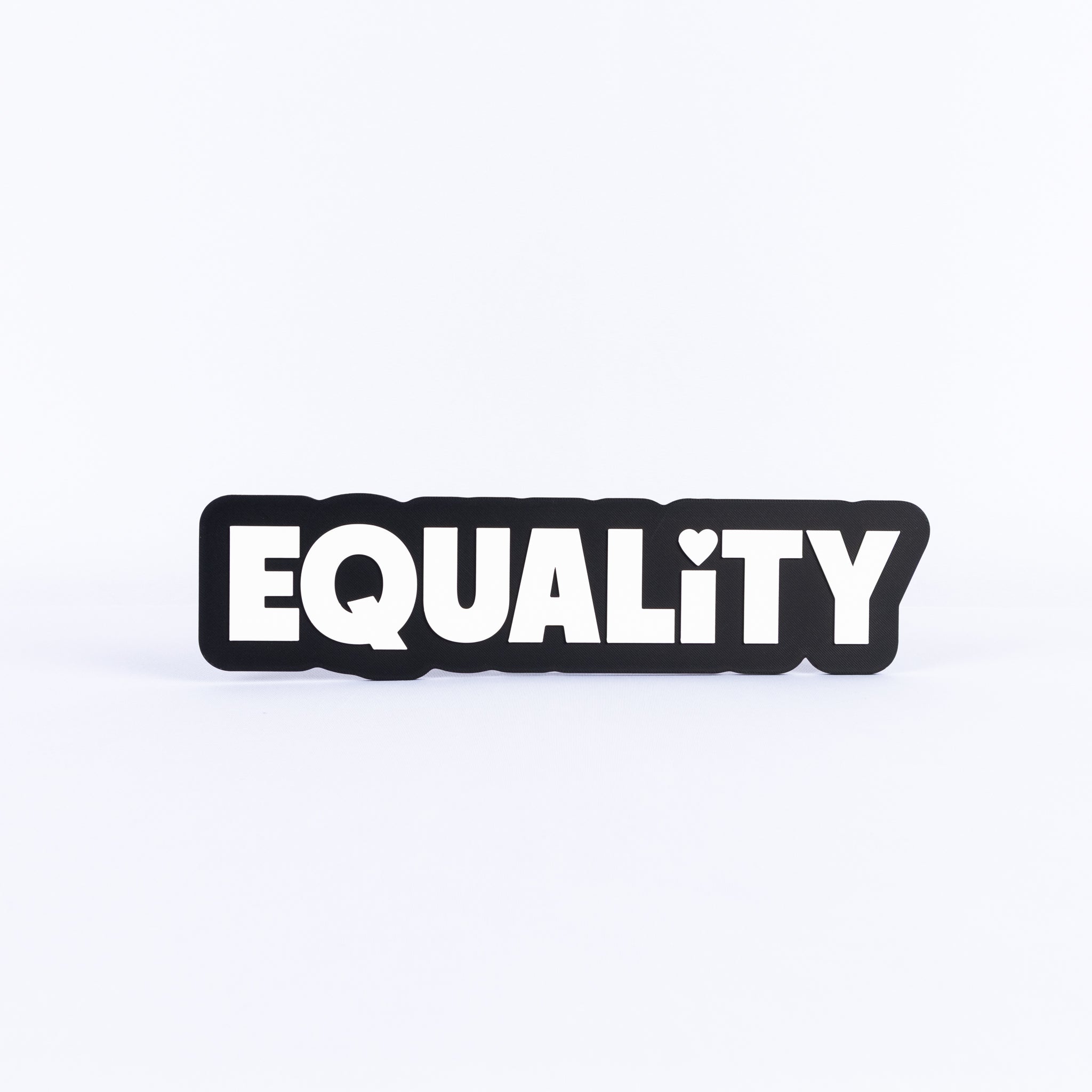 Black and white sign with the word 'EQUALITY' on a white background