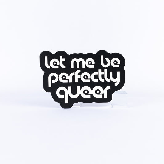 Black and white sign with white text 'Let me be perfectly queer' on a white background