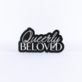 Black and white sign with 'Queerly Beloved' text on a white background