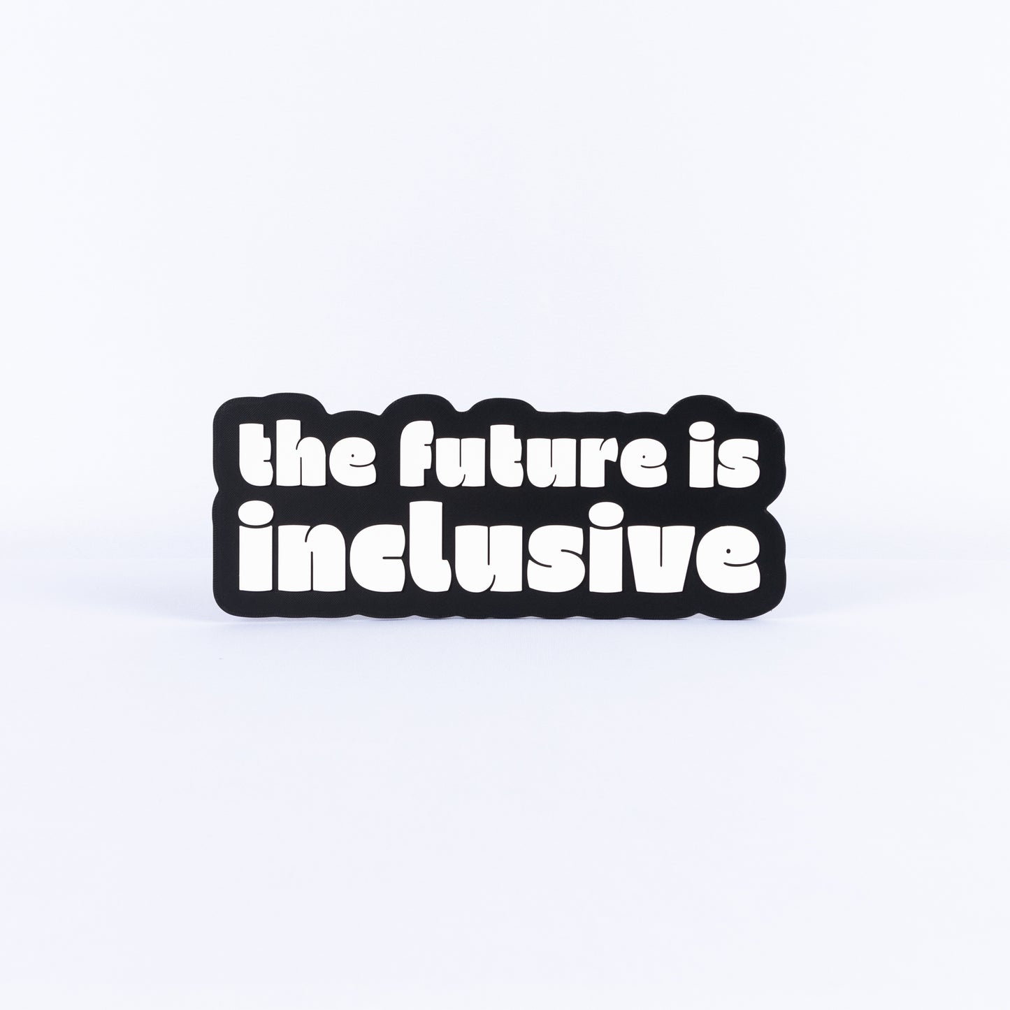 Black and white sign with 'the future is inclusive' text on a white background