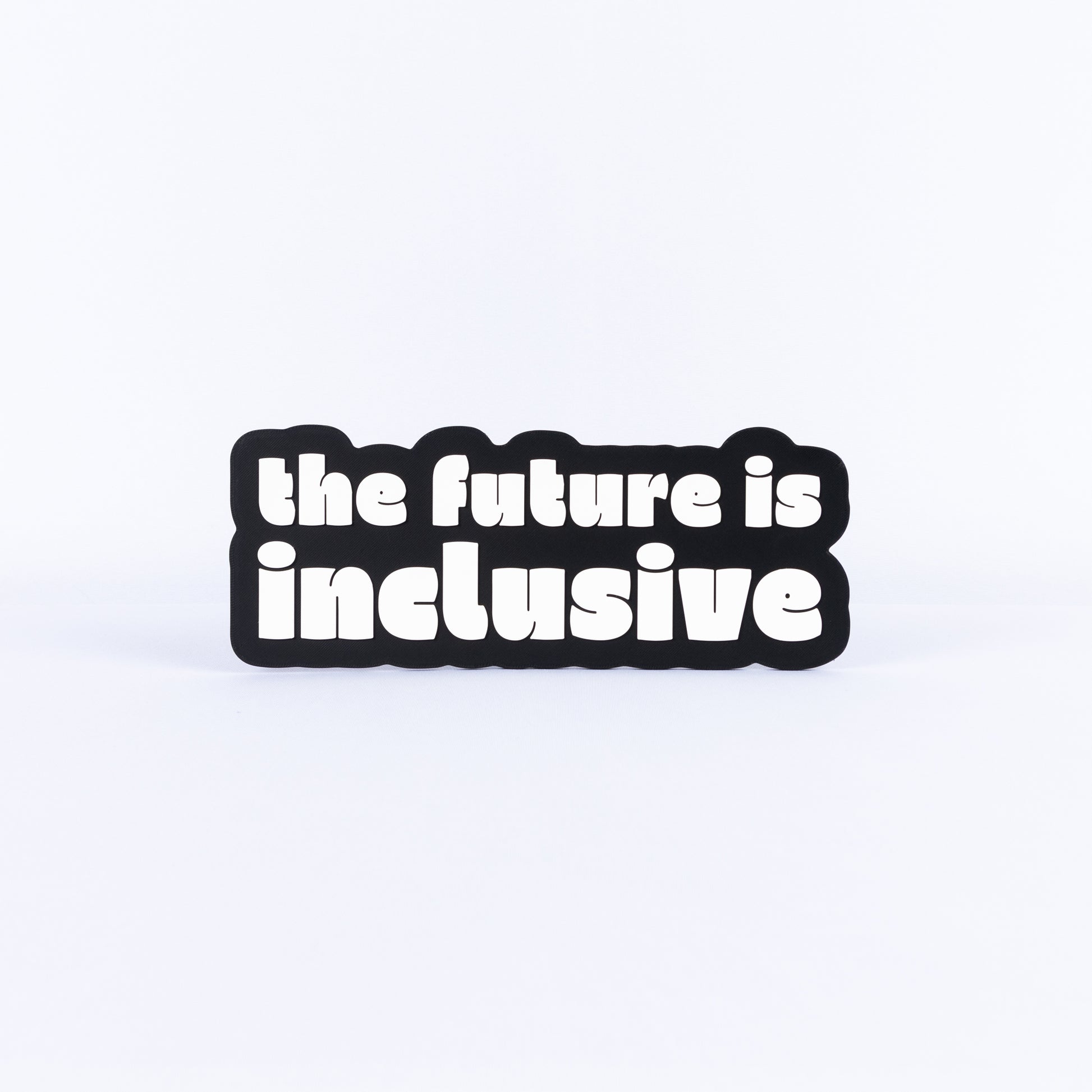 Black and white sign with 'the future is inclusive' text on a white background