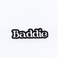 Black and white sign with 'Baddie' text on a white background