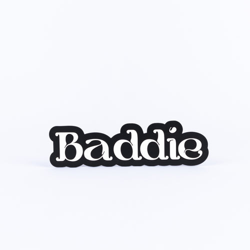 Black and white sign with 'Baddie' text on a white background