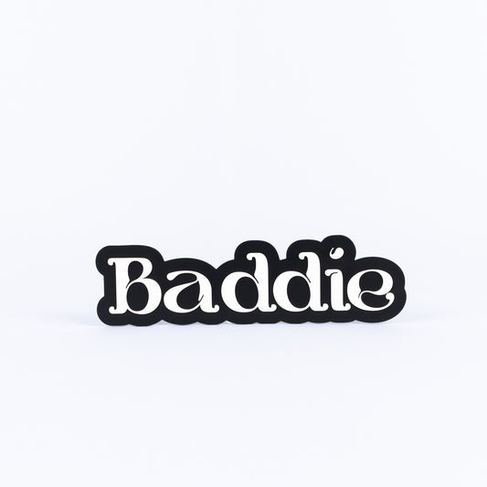 Black and white sign with 'Baddie' text on a white background