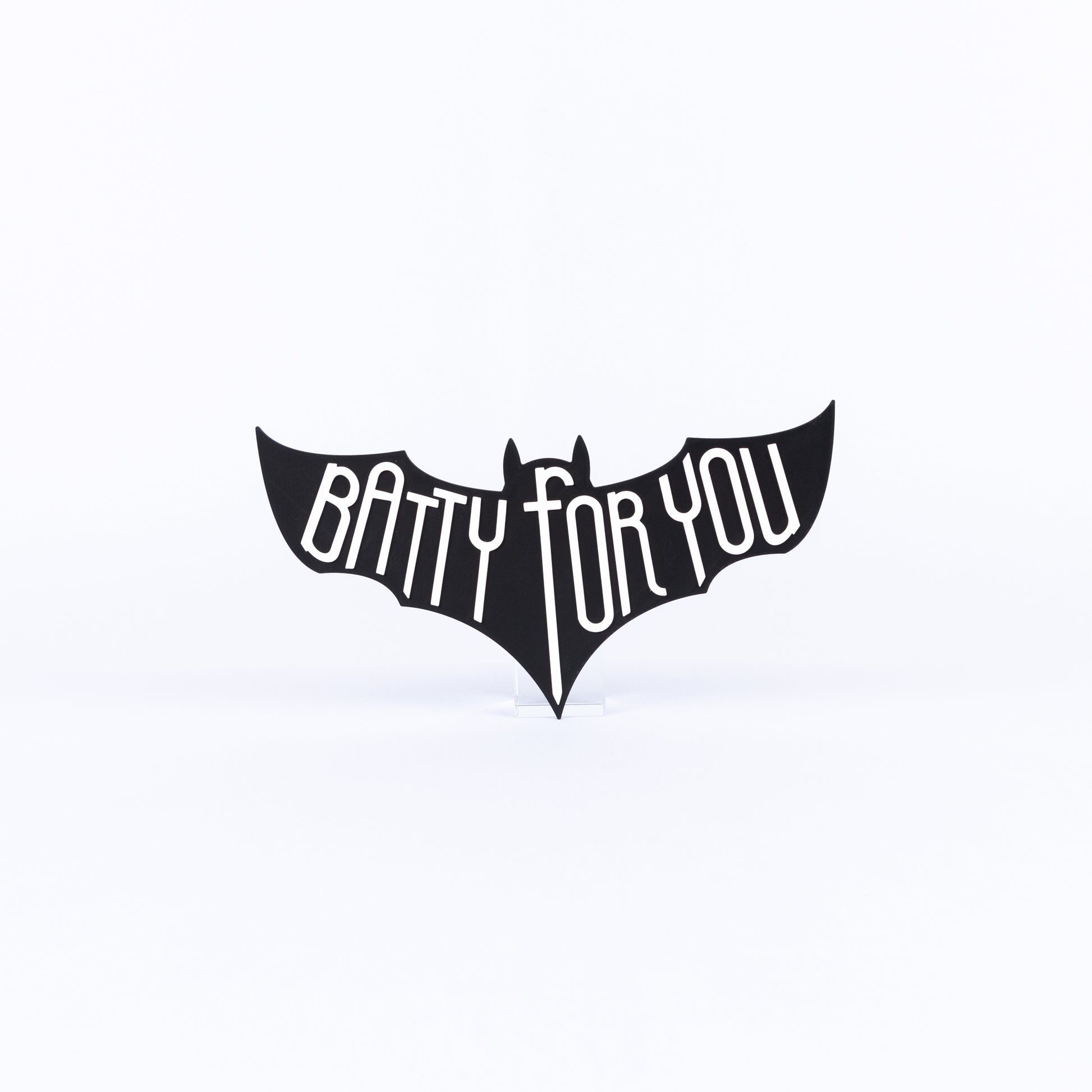 Black bat-shaped sign with 'Batty For You' white text on a white background